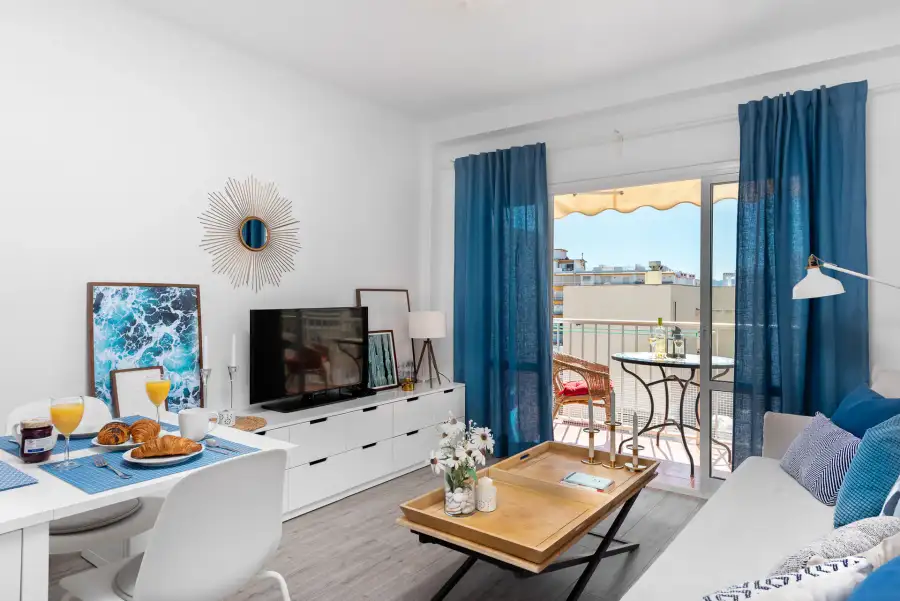 Salón comedor en azul y blanco con balcón en AMARA Playa, Nerja
